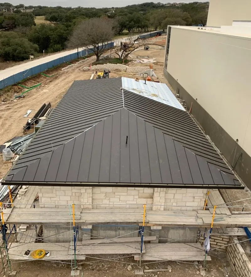 Metal roof new construction with scaffolding in Bedford